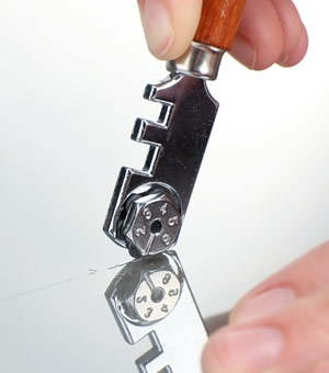 Expert glazier cutting single glass pane